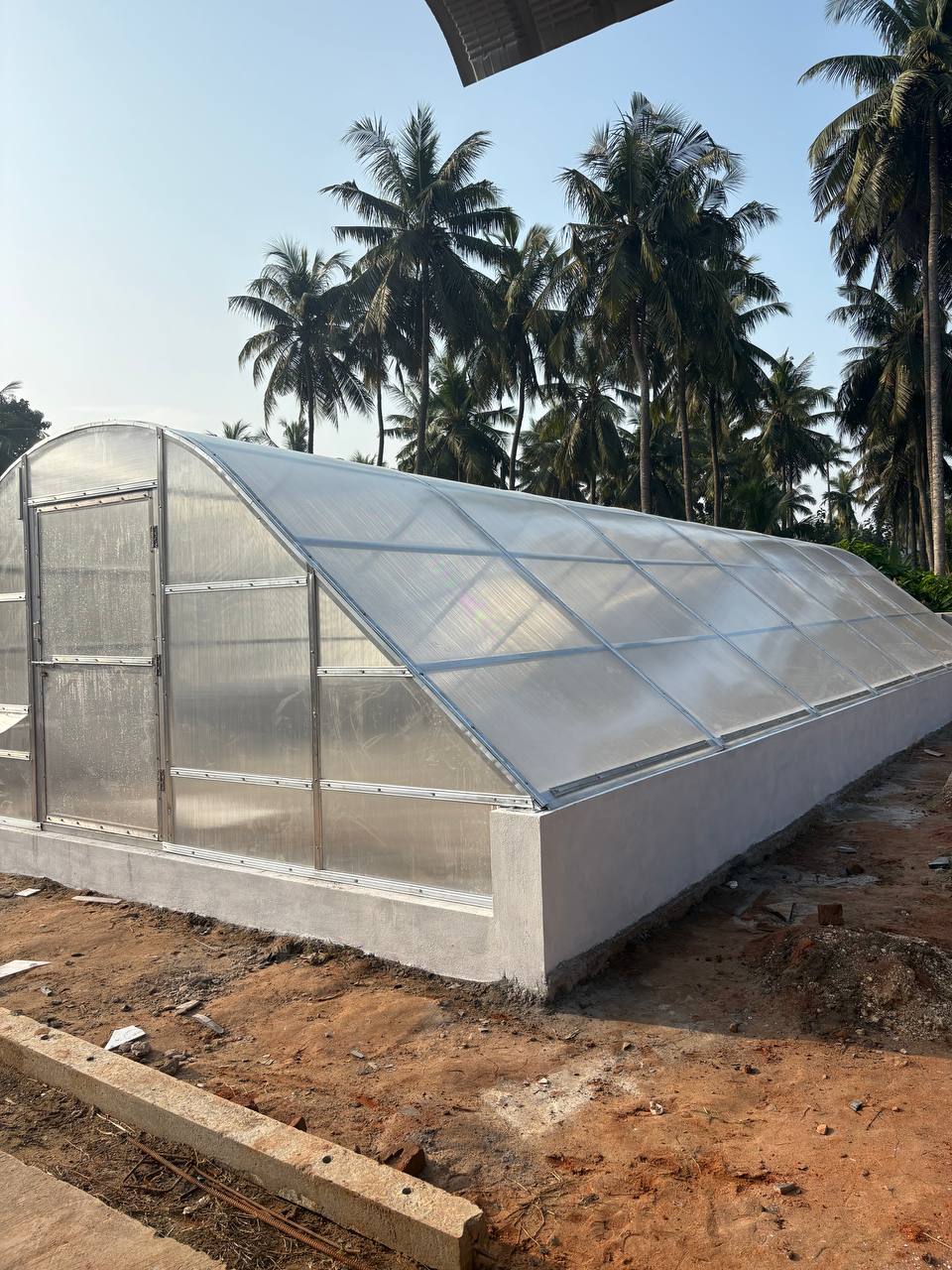 Solar tunnel dryer interior with drying trays — Verdant Farms